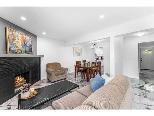 19-4940 39 Avenue Sw, Calgary, AB - Indoor Photo Showing Living Room With Fireplace