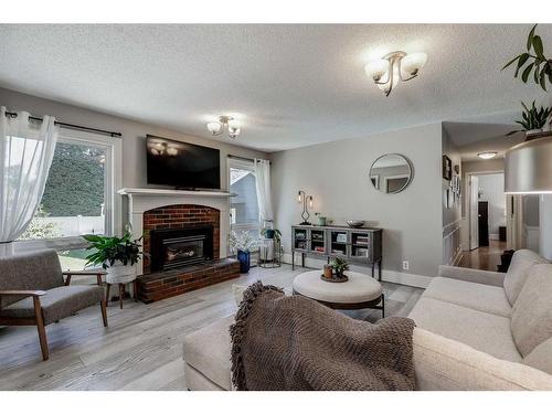 516 Willacy Drive Se, Calgary, AB - Indoor Photo Showing Living Room With Fireplace