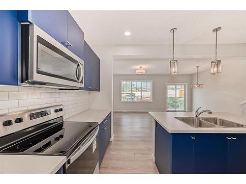 1485 Bayview Point, Airdrie, AB - Indoor Photo Showing Kitchen With Double Sink With Upgraded Kitchen