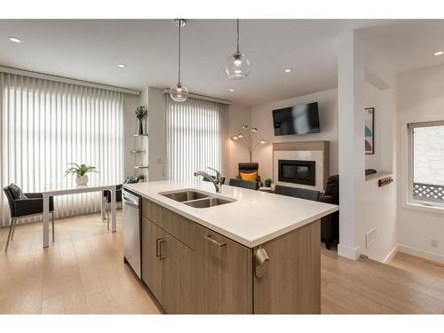 2-1913 30 Street Sw, Calgary, AB - Indoor Photo Showing Kitchen With Fireplace With Double Sink