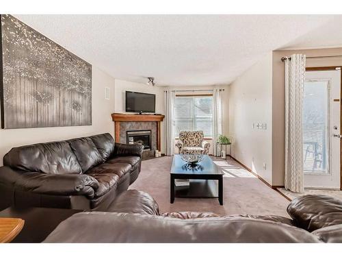 15225 Prestwick Boulevard Se, Calgary, AB - Indoor Photo Showing Living Room With Fireplace