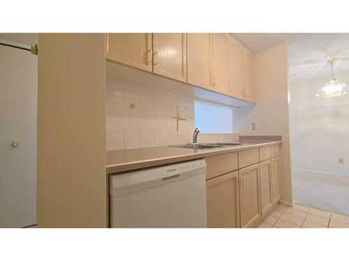 305-723 57 Avenue Sw, Calgary, AB - Indoor Photo Showing Kitchen With Double Sink