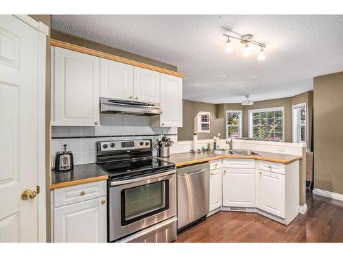 170 Rocky Ridge Point Nw, Calgary, AB - Indoor Photo Showing Kitchen With Double Sink