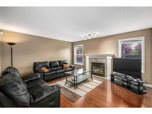 170 Rocky Ridge Point Nw, Calgary, AB - Indoor Photo Showing Living Room With Fireplace