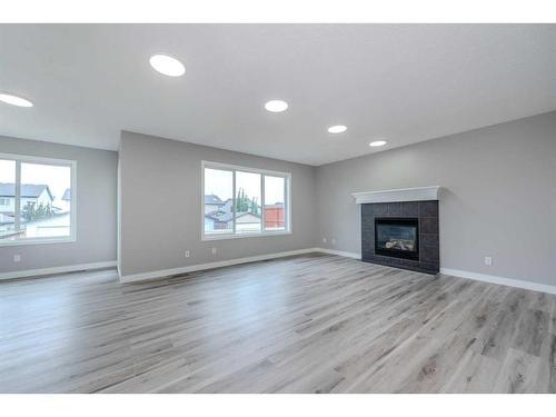 434 Coopers Drive Sw, Airdrie, AB - Indoor Photo Showing Living Room With Fireplace