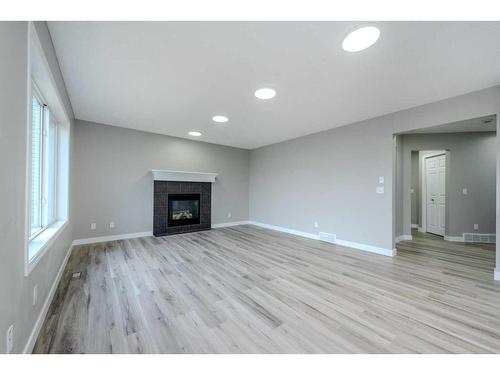 434 Coopers Drive Sw, Airdrie, AB - Indoor Photo Showing Living Room With Fireplace