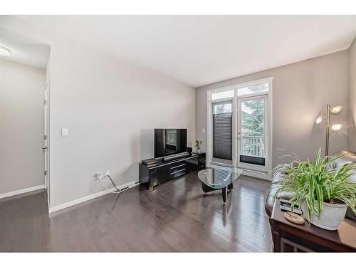 1610-125 Panatella Way Nw, Calgary, AB - Indoor Photo Showing Living Room