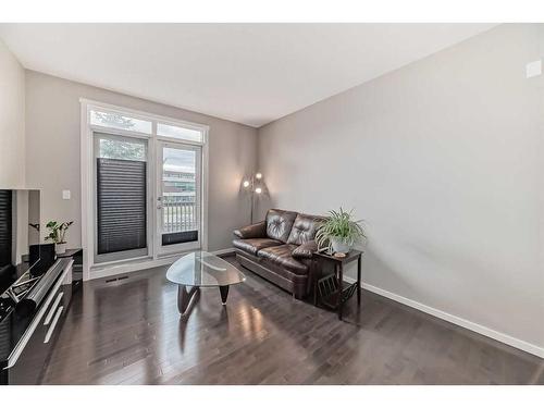 1610-125 Panatella Way Nw, Calgary, AB - Indoor Photo Showing Living Room