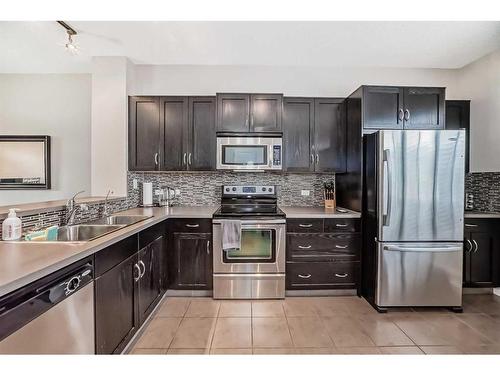 1610-125 Panatella Way Nw, Calgary, AB - Indoor Photo Showing Kitchen With Stainless Steel Kitchen With Double Sink With Upgraded Kitchen