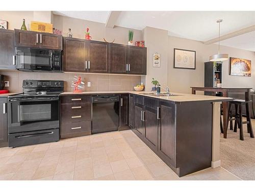 114 New Brighton Landing Se, Calgary, AB - Indoor Photo Showing Kitchen With Double Sink