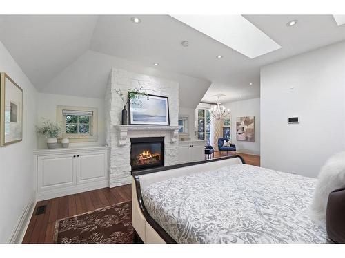 1131 Dorchester Avenue Sw, Calgary, AB - Indoor Photo Showing Bedroom With Fireplace