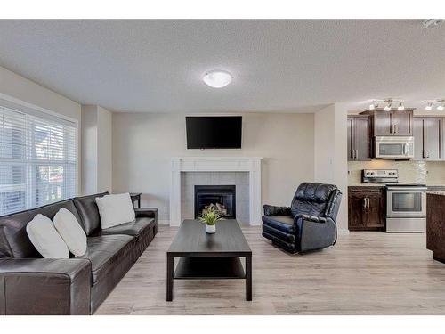 128 Copperpond Parade Se, Calgary, AB - Indoor Photo Showing Living Room With Fireplace