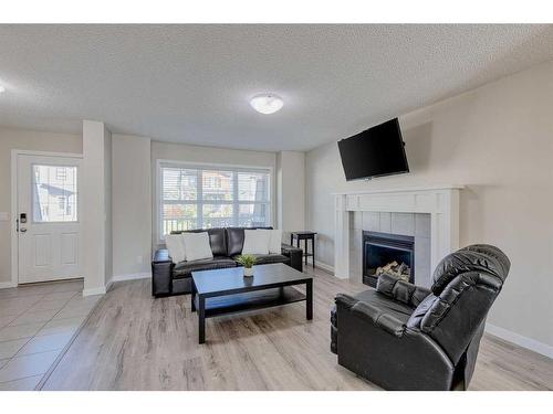 128 Copperpond Parade Se, Calgary, AB - Indoor Photo Showing Living Room With Fireplace