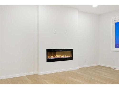 907 Langholm Drive Se, Airdrie, AB - Indoor With Fireplace