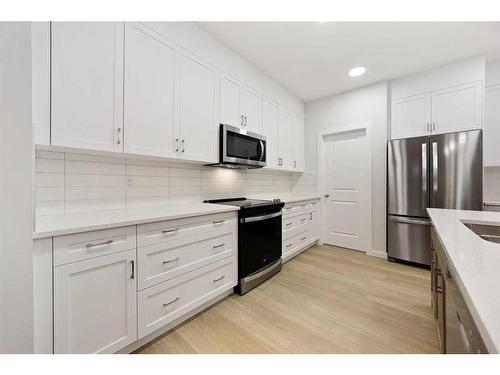 907 Langholm Drive Se, Airdrie, AB - Indoor Photo Showing Kitchen With Upgraded Kitchen