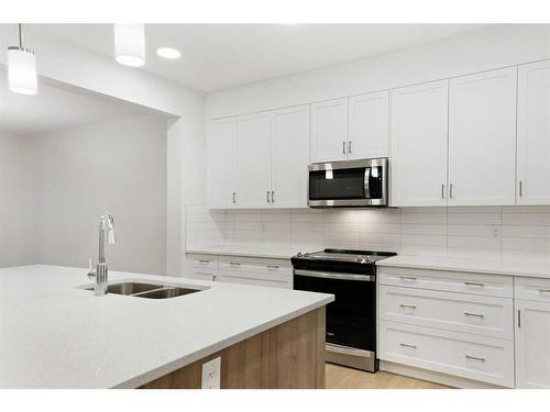 907 Langholm Drive Se, Airdrie, AB - Indoor Photo Showing Kitchen With Double Sink With Upgraded Kitchen