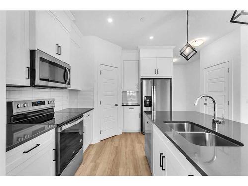 304 Hotchkiss Drive Se, Calgary, AB - Indoor Photo Showing Kitchen With Double Sink With Upgraded Kitchen