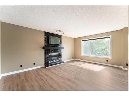 164 Schooner Close Nw, Calgary, AB - Indoor Photo Showing Living Room With Fireplace