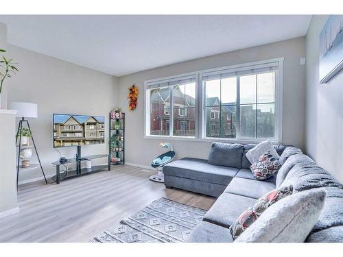 1406-125 Panatella Way Nw, Calgary, AB - Indoor Photo Showing Living Room