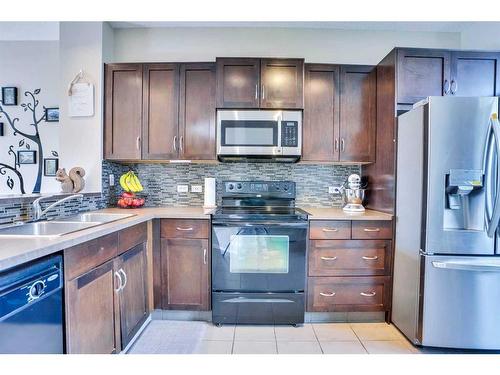 1406-125 Panatella Way Nw, Calgary, AB - Indoor Photo Showing Kitchen With Double Sink