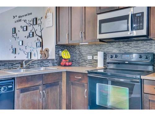 1406-125 Panatella Way Nw, Calgary, AB - Indoor Photo Showing Kitchen With Double Sink