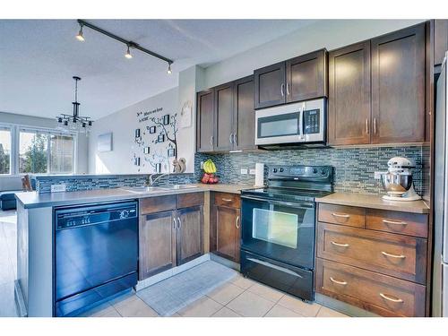 1406-125 Panatella Way Nw, Calgary, AB - Indoor Photo Showing Kitchen With Double Sink