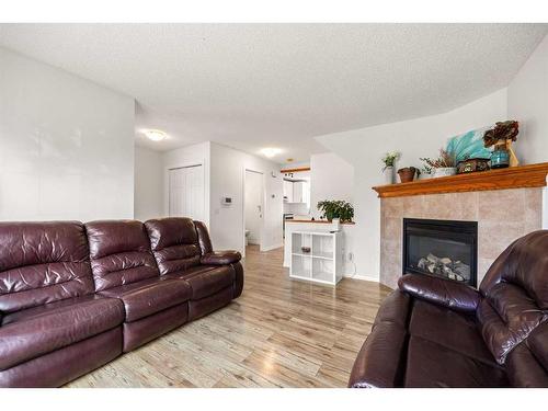 189 Everridge Way Sw, Calgary, AB - Indoor Photo Showing Living Room With Fireplace