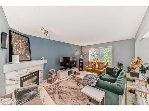 64 Bridlewood Garden Sw, Calgary, AB - Indoor Photo Showing Living Room With Fireplace