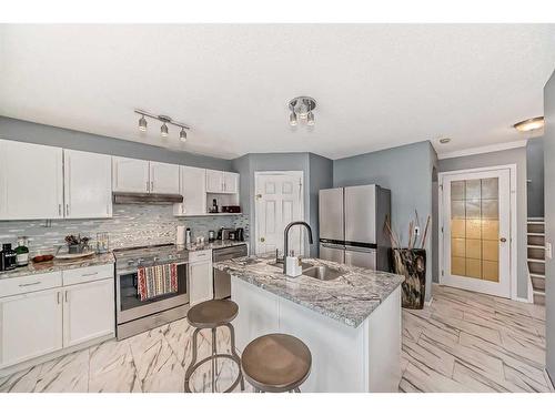 64 Bridlewood Garden Sw, Calgary, AB - Indoor Photo Showing Kitchen With Double Sink With Upgraded Kitchen