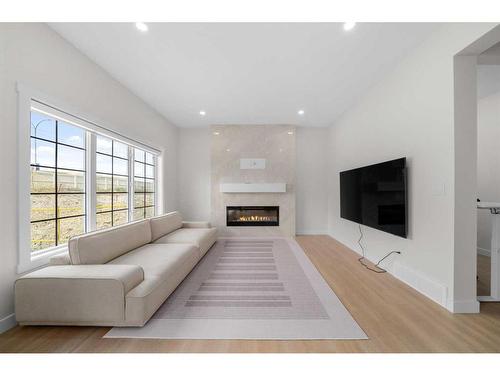 921 Bayview Heights Sw, Airdrie, AB - Indoor Photo Showing Living Room With Fireplace