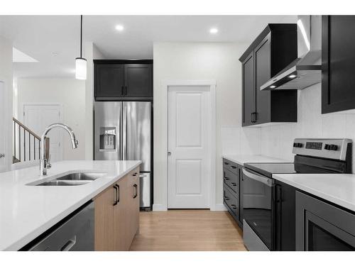 921 Bayview Heights Sw, Airdrie, AB - Indoor Photo Showing Kitchen With Stainless Steel Kitchen With Double Sink With Upgraded Kitchen