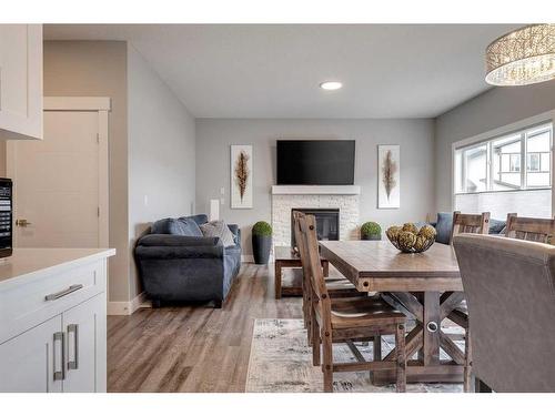 1360 Lackner Boulevard, Carstairs, AB - Indoor Photo Showing Dining Room With Fireplace