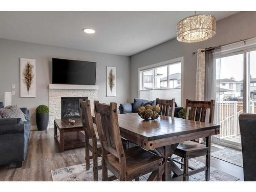 1360 Lackner Boulevard, Carstairs, AB - Indoor Photo Showing Dining Room With Fireplace