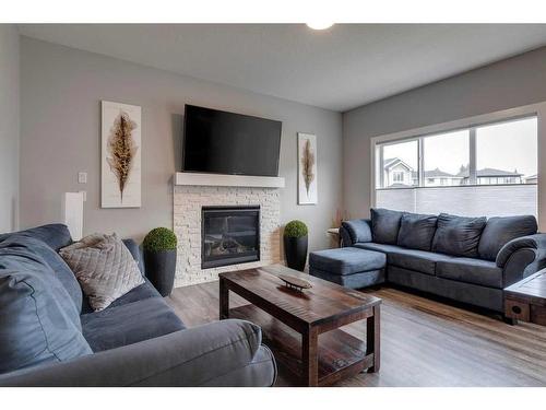 1360 Lackner Boulevard, Carstairs, AB - Indoor Photo Showing Living Room With Fireplace