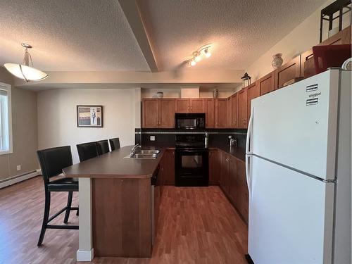 1215-211 Aspen Stone Boulevard Sw, Calgary, AB - Indoor Photo Showing Kitchen With Double Sink