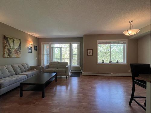 1215-211 Aspen Stone Boulevard Sw, Calgary, AB - Indoor Photo Showing Living Room