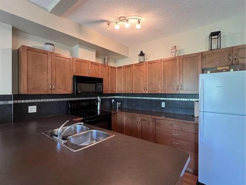 1215-211 Aspen Stone Boulevard Sw, Calgary, AB - Indoor Photo Showing Kitchen With Double Sink