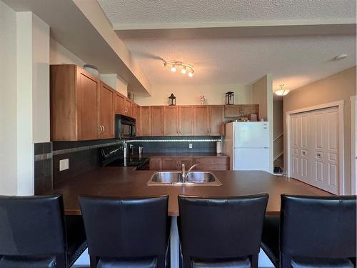 1215-211 Aspen Stone Boulevard Sw, Calgary, AB - Indoor Photo Showing Kitchen With Double Sink