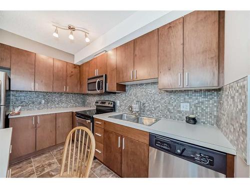 204-11 Millrise Drive Sw, Calgary, AB - Indoor Photo Showing Kitchen With Stainless Steel Kitchen With Double Sink