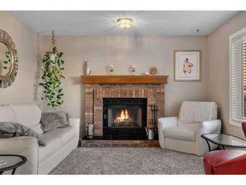 217 Riverwood Close Se, Calgary, AB - Indoor Photo Showing Living Room With Fireplace