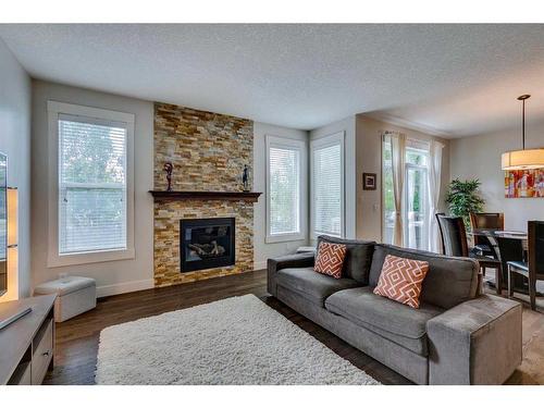 85 Aspenshire Crescent Sw, Calgary, AB - Indoor Photo Showing Living Room With Fireplace