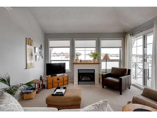 1312-1010 Arbour Lake Road Nw, Calgary, AB - Indoor Photo Showing Living Room With Fireplace