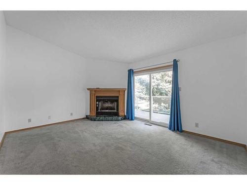 140 Prominence Heights Sw, Calgary, AB - Indoor Photo Showing Living Room With Fireplace