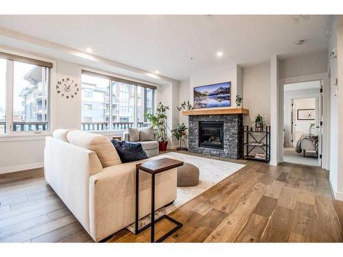 209-1315 Spring Creek Gate, Canmore, AB - Indoor Photo Showing Living Room With Fireplace