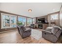 209 Kinniburgh Boulevard, Chestermere, AB  - Indoor Photo Showing Living Room With Fireplace 