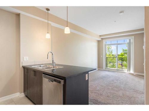 312-117 Copperpond Common Se, Calgary, AB - Indoor Photo Showing Kitchen With Double Sink