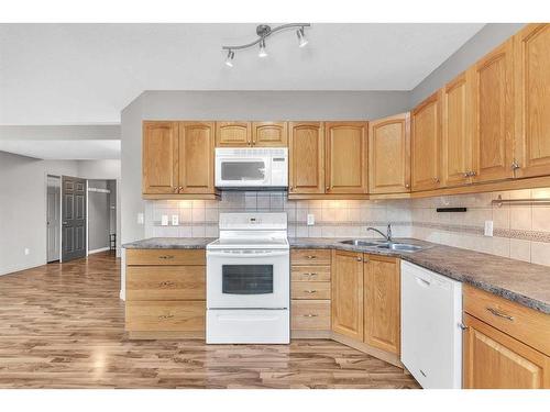 213 West Lakeview Place, Chestermere, AB - Indoor Photo Showing Kitchen With Double Sink