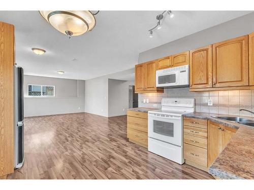 213 West Lakeview Place, Chestermere, AB - Indoor Photo Showing Kitchen With Double Sink