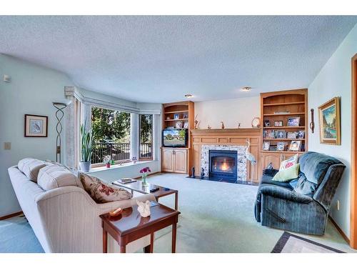 108 Edgebrook Place Nw, Calgary, AB - Indoor Photo Showing Living Room With Fireplace