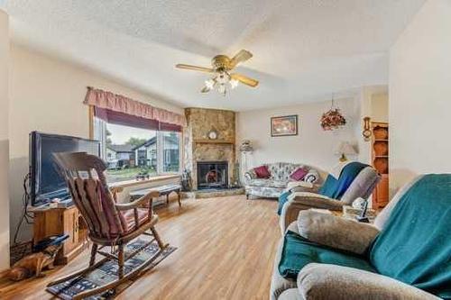 807 Olympia Crescent Se, Calgary, AB - Indoor Photo Showing Living Room With Fireplace